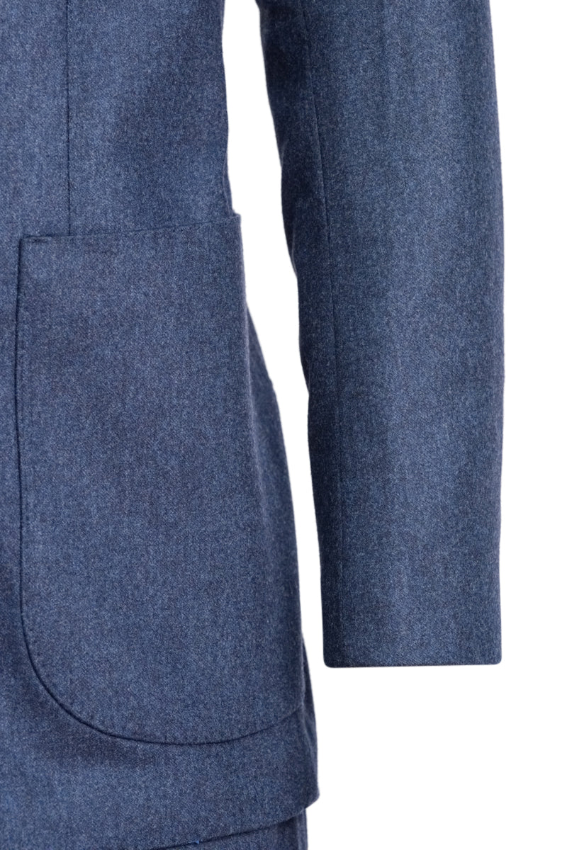 Close-up of a blue textured fabric with a pocket on a white background