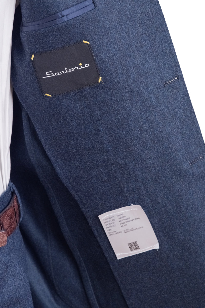 Close-up of a blue garment with a Santonio label on a white background