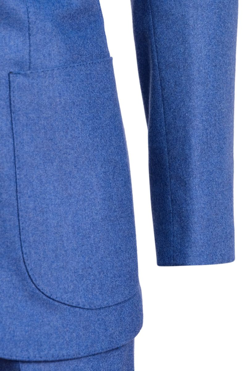 Close-up of a blue textured fabric with a pocket detail on a white background